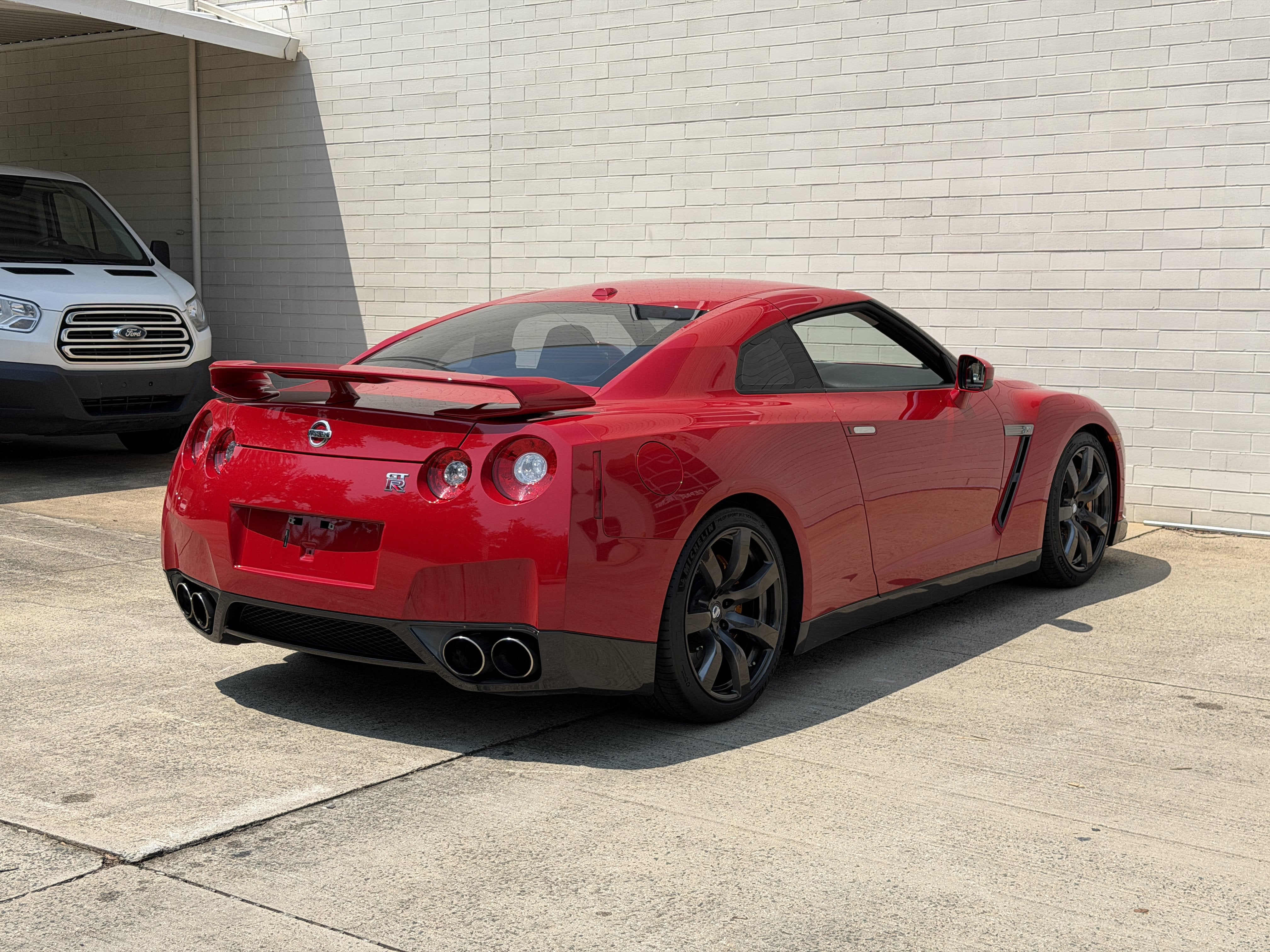 Used 2010 Solid Red Nissan Premium image 7